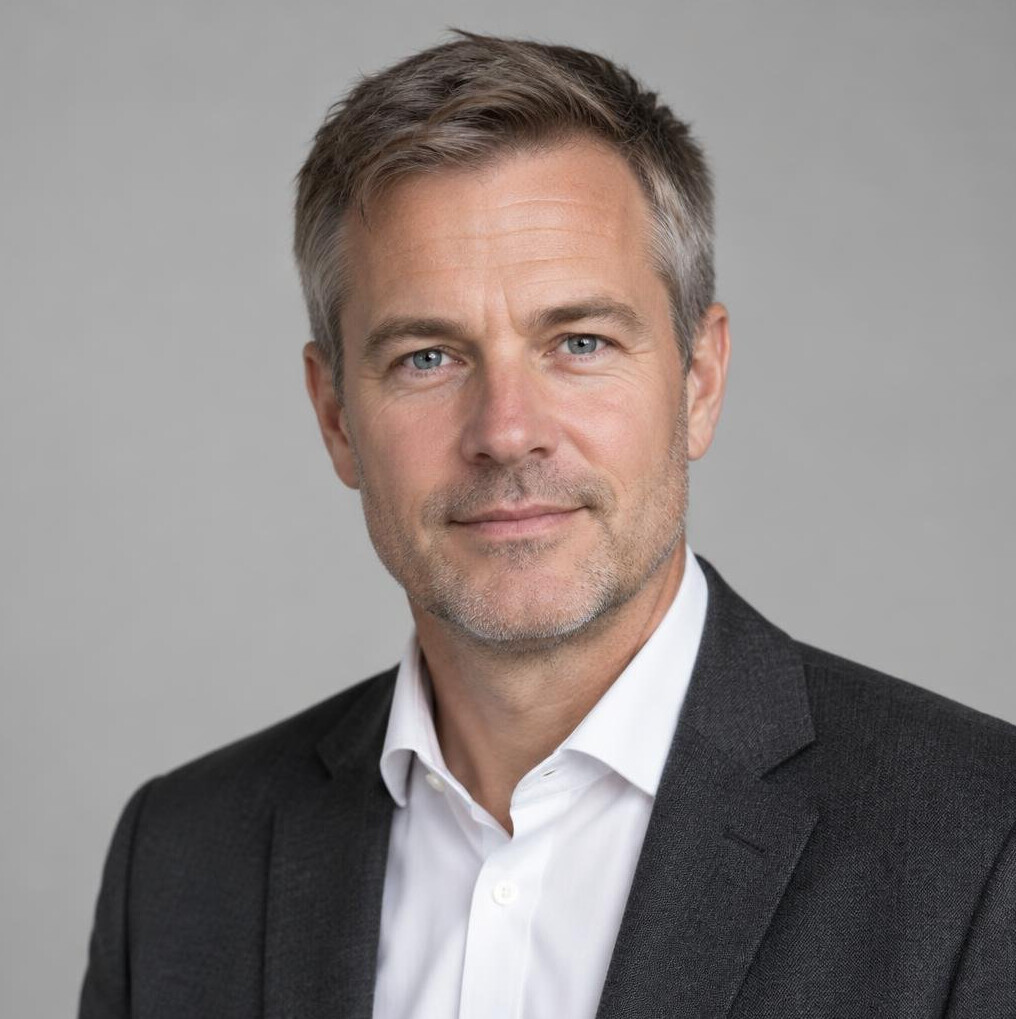 Portrait of a man with short dark hair in a suit